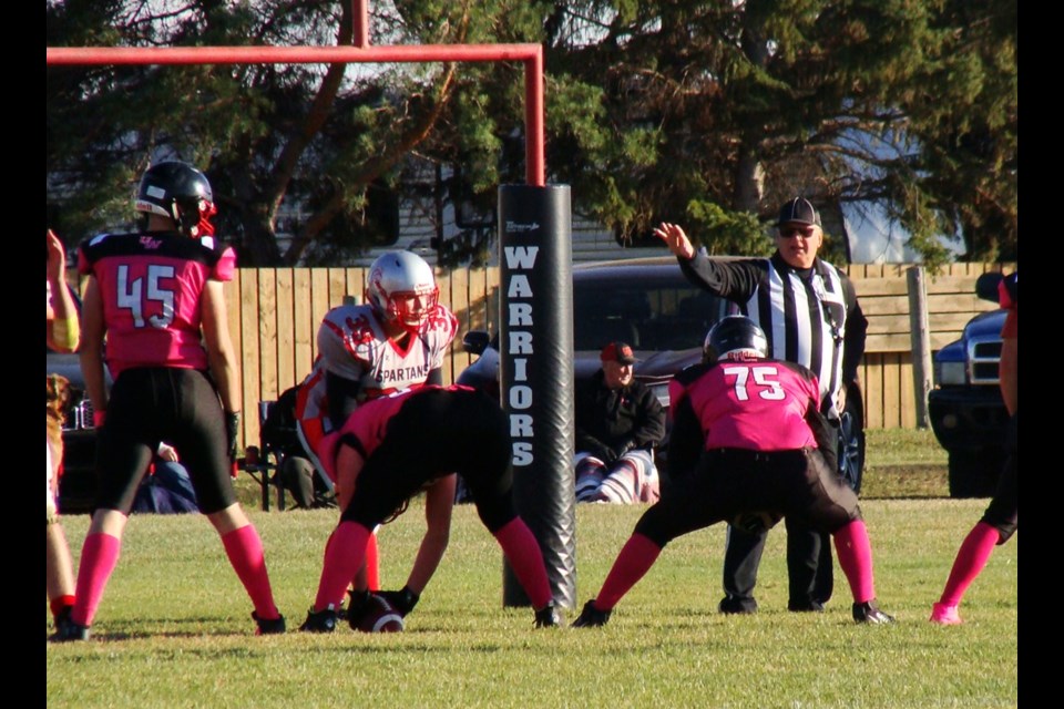 With only one yard to go, Warriors Reid Ducherer (left) flanks Dane Rewerts (centre) as Rylan Fauth (right) waits to receive the snap.                       